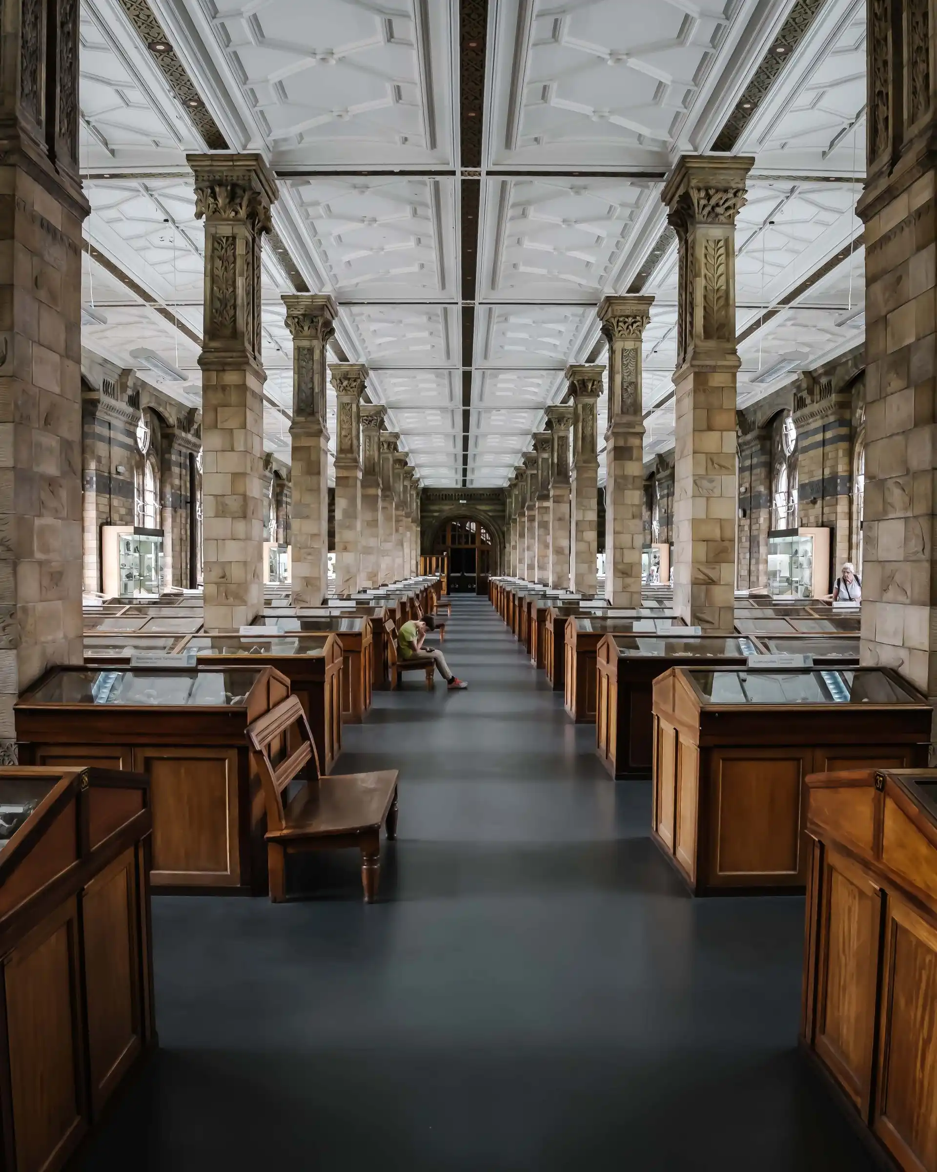 A boy sitting in a empty museum hall